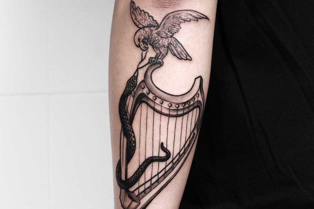 Hawk-snake-and-harp-done-at-High-Tension-Tattoo.jpeg